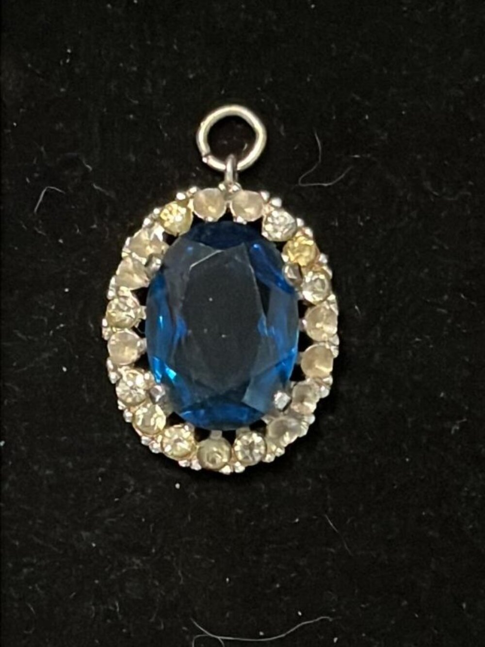 Dark Blue Stone Surrounded by Clear Stones Pendant